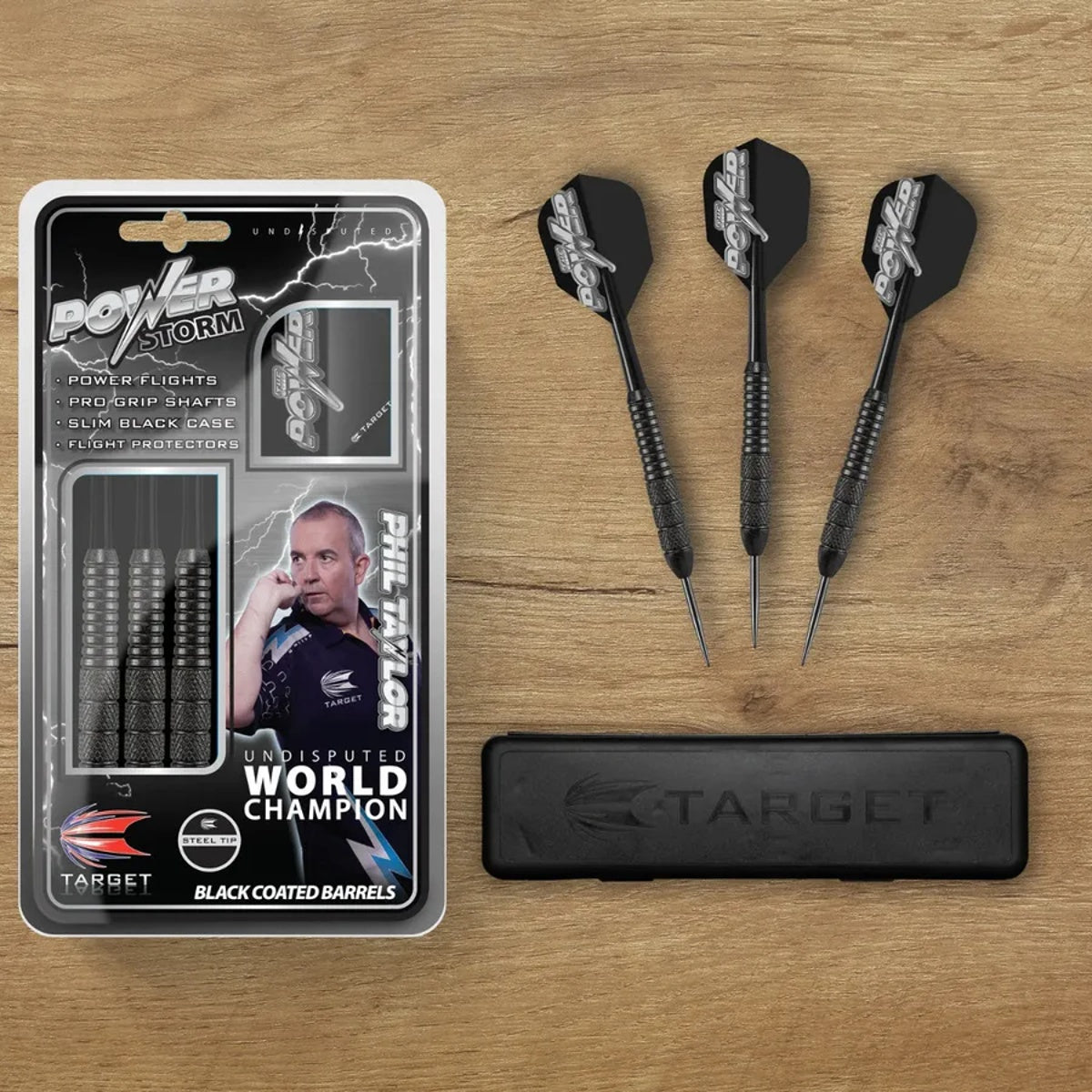 Phil Taylor Power Storm darts set with case and darts laid out on wood surface