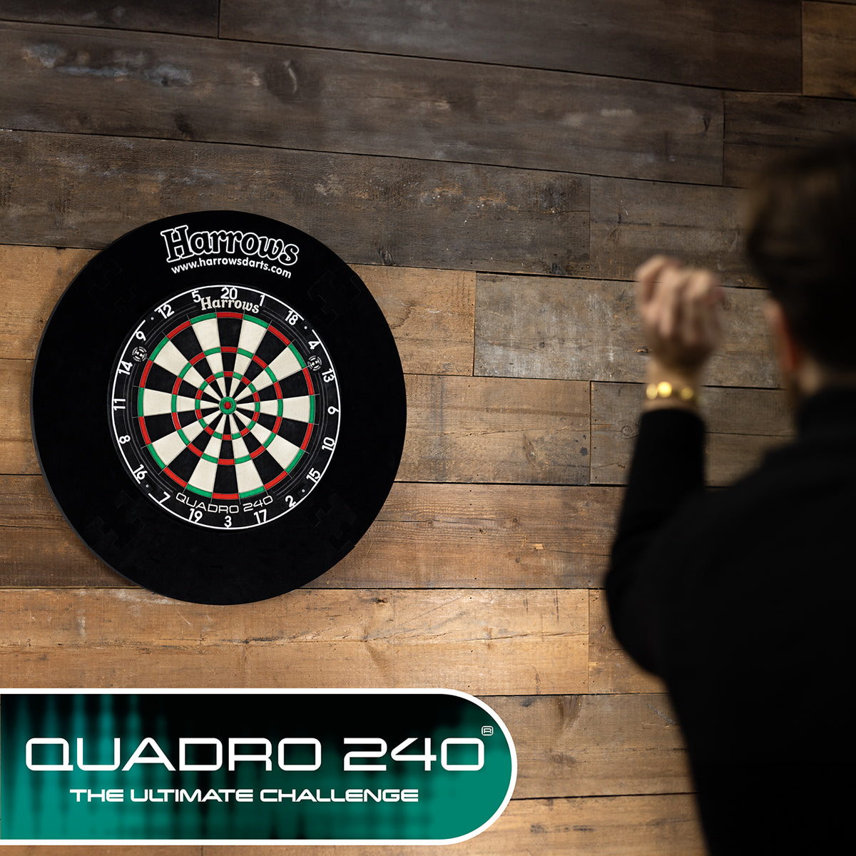 Harrows Quadro 240 Dartboard lifestyle image showing the dartboard installed and ready for play in a real world setting with a player using the dartboard