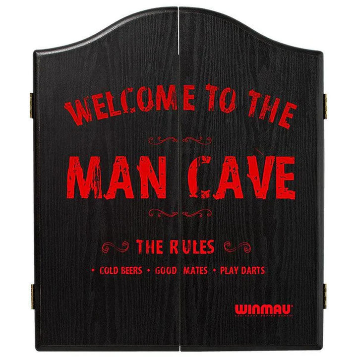 Closed Winmau dartboard cabinet with black woodgrain finish and bold red "Welcome to the Man Cave" text.